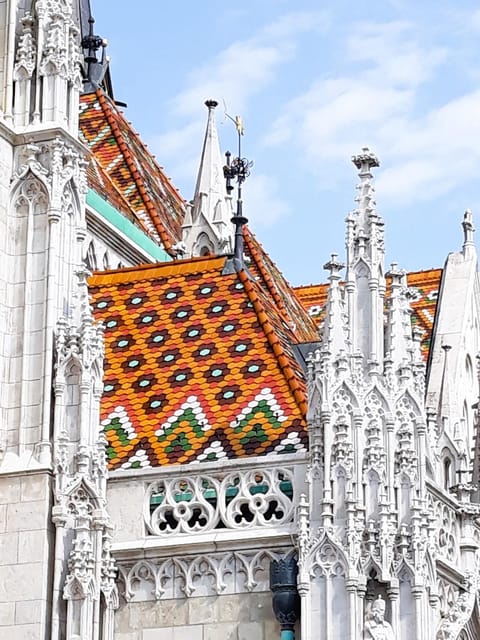 Budapest: Buda Castle Walking Tour & Folk Music Performance - Government buildings and the story of King Matthias